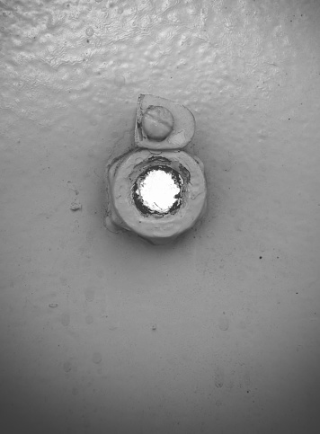peephole in a old prison in black and white