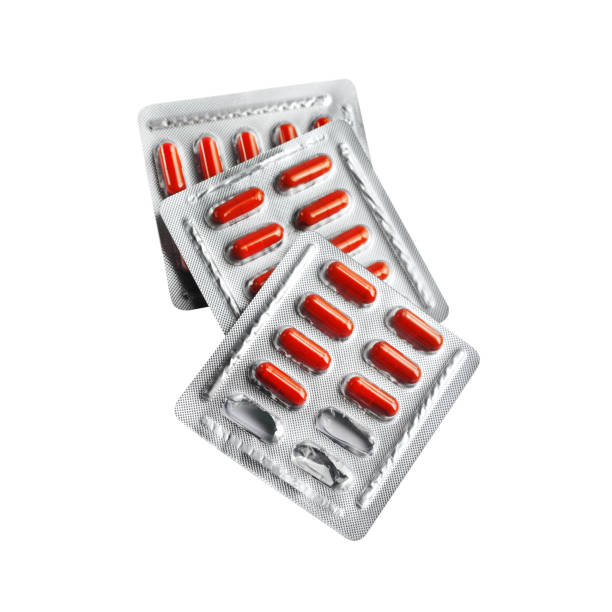 istock Red pill capsules in blister packs isolated on white background 1135152458