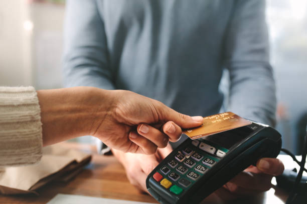 istock Pharmacist accepting credit card by contactless payment 1135152523
