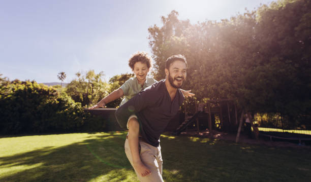 istock Father and son having fun playing in the park 1135153666
