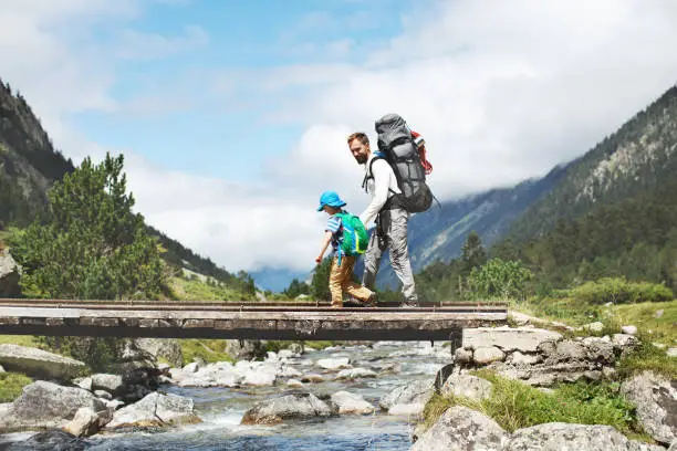 Father and son hiking together in mountains