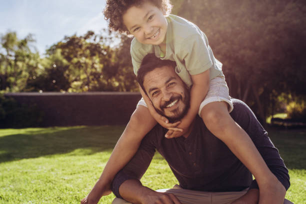 istock Father and son sitting in park 1135153752