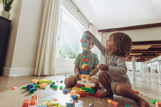 istock Kids playing with building blocks at home 1135153807