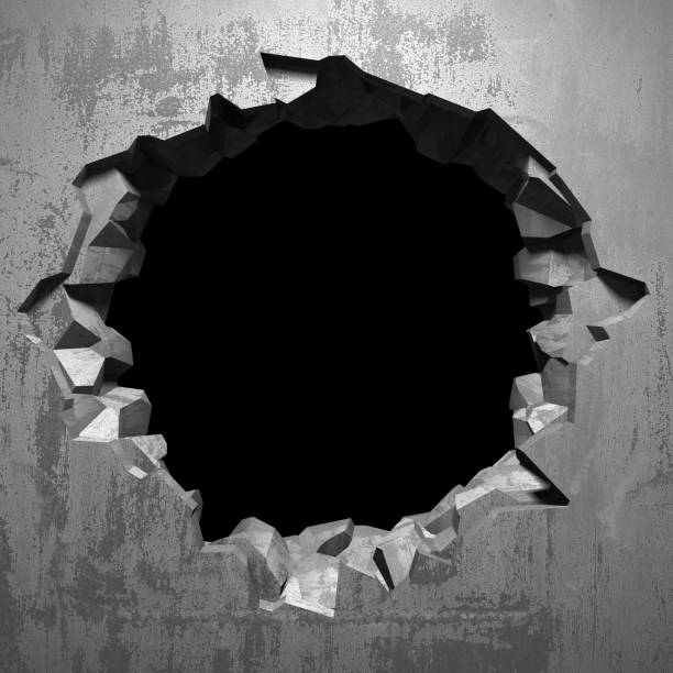 istock Dark cracked broken hole in concrete wall 1135153884