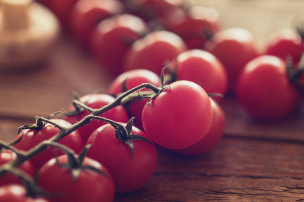 istock Cherry tomatoes at wood table, close up 1135154318
