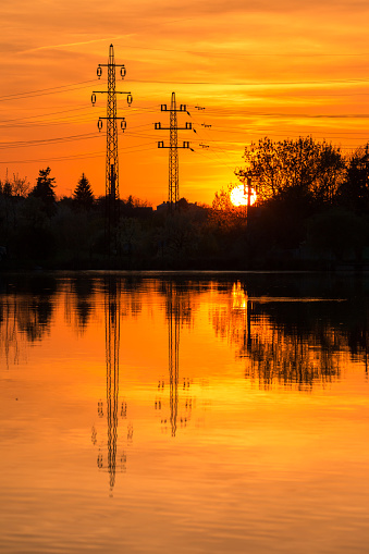 Electricity pylons on sunset background.