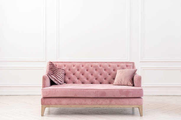 istock Modern living-room minimalistic  interior with pink sofa near empty white wall. - Image 1135156289