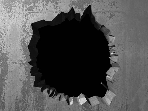 istock Dark cracked broken hole in concrete wall 1135156582