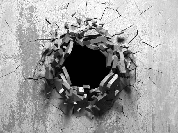 istock Dark cracked broken hole in concrete wall 1135156781