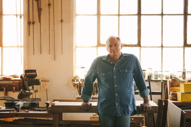 istock Senior man standing by a table in his carpentry workshop 1135158345