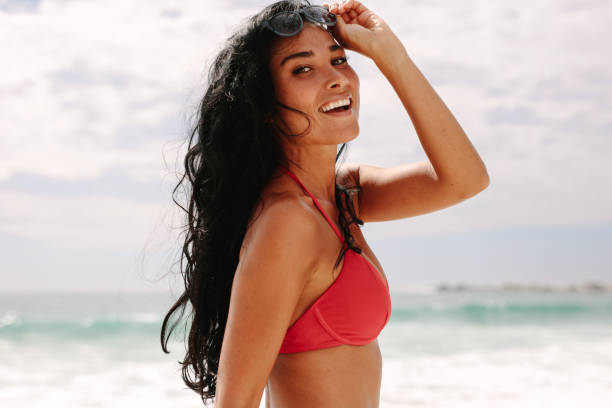 istock Woman enjoying summer holidays on beach 1135158958