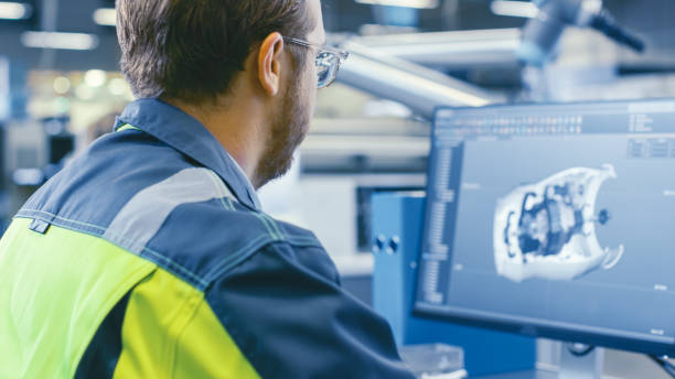 istock Back Shot of an Mechanical Engineer Working on Computers, Designing in 3D Model of the Engine using CAD Software. At the Factory. 1135159497
