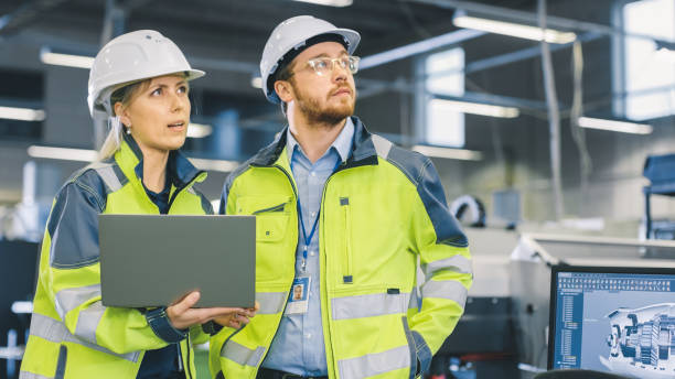 istock Inside the Manufacturing Factory Male Mechanical Engineer Works on Personal Computer Under Supervision of Female Chief Project Engineer. 1135159610