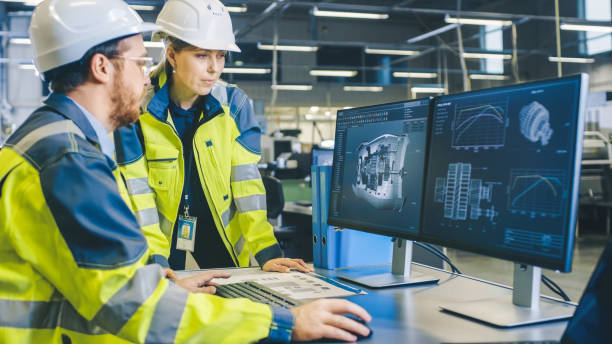 istock At the Factory: Male Mechanical Engineer and Female Chief Engineer Work Together on the Personal Computer, They Discuss Details of the 3D Engine Model Design. 1135159613