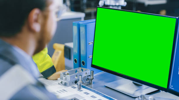 istock Close-up Back View of the Mechanical Engineer Working on Personal Computer with Green Screen Mock up GReat for Template. Professional Working At the Factory. 1135159664