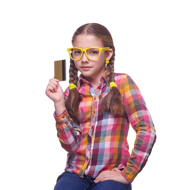 Beautiful teen girl with credit card on white background stock photo