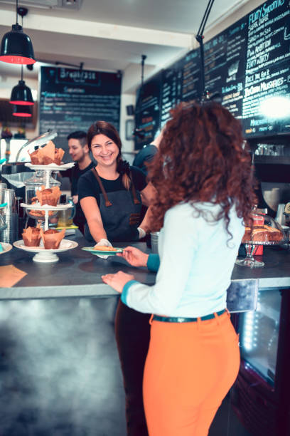 istock Cute Female Ordering Cake In Modern Restaurant 1135159894