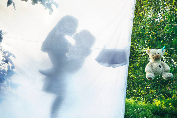 Mother and her son hanging laundry on a clothes line. Concept for mother's love.