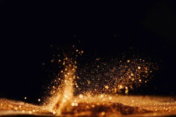 Photo of glitter vintage lights background. gold and black. de focused