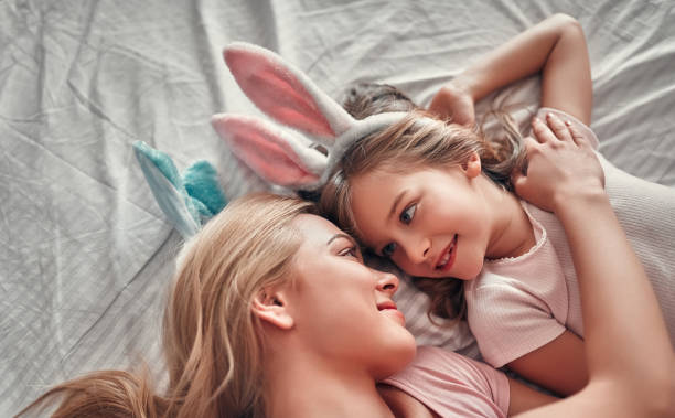 istock Mother with daughter on bed 1135164941