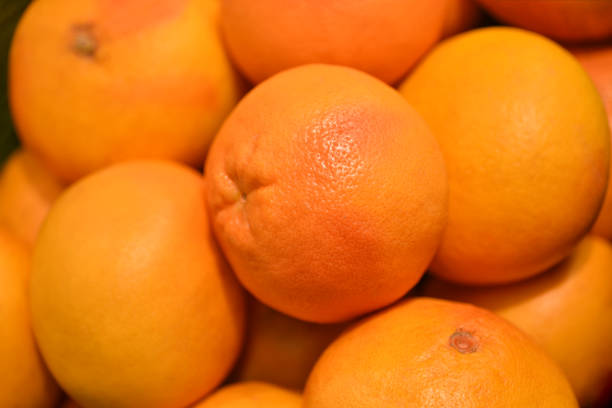 istock Food fruit fresh yellow grapefruit background. Fresh grapefruit pattern for sale in market. Agriculture and fruits product. Selective focus 1135165164