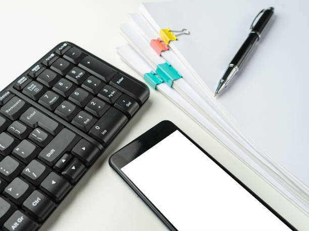 istock Office desk table with computer keyboard and supplies. On white background. Copy space. Mock up. 1135166303