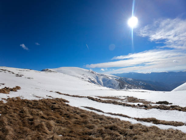 istock Snow hill with sunrise on mountain range 1135166936