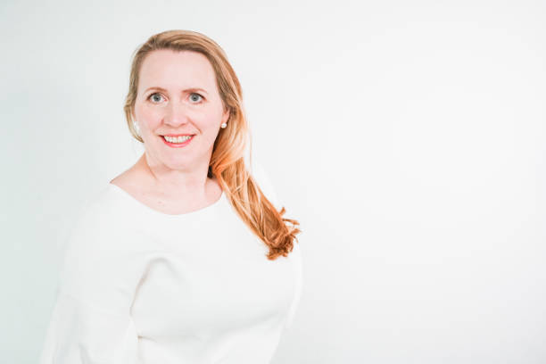 istock Studio portrait of smiling middle aged woman. 1135168507