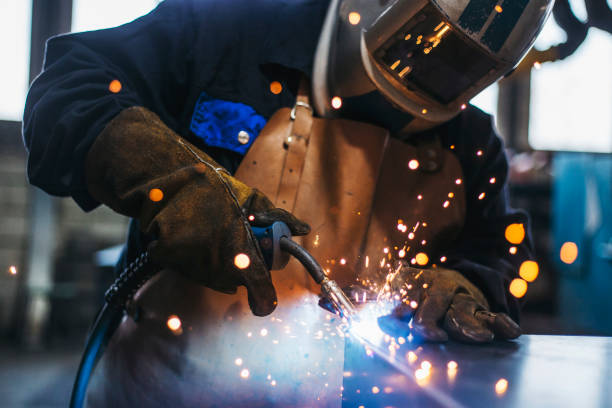 industrial welder with torch - soldar imagens e fotografias de stock