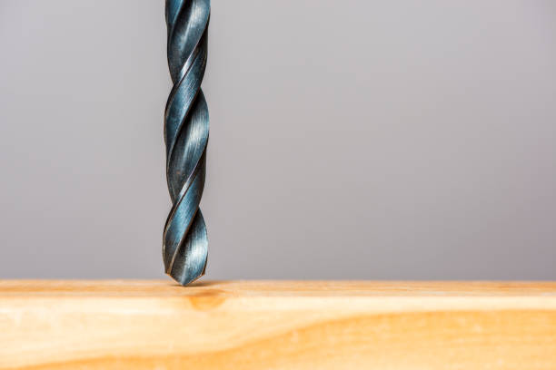 istock drilling a hole in a wooden plank 1135169094