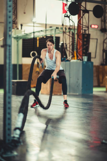 istock Athlete working out with battle ropes at cross gym 1135171483