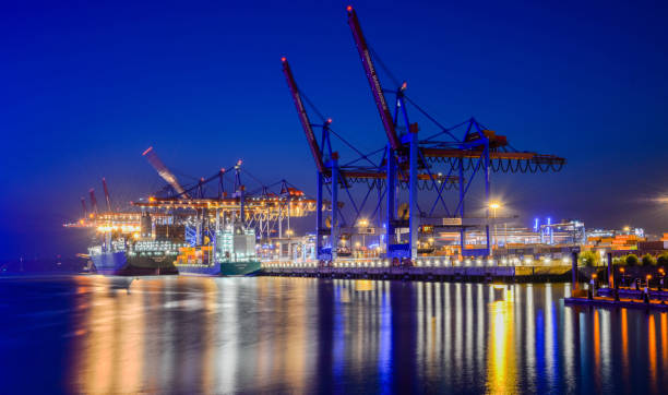 istock Cranes to clear cargo of ships at night 1135171986