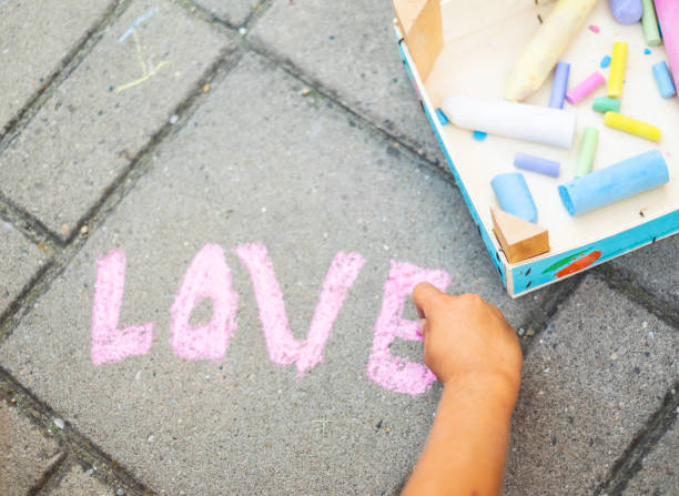 istock Human hand writing with chalk on concrete 1135172547