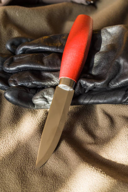 istock Knife and leather gloves. A sharp hunting knife. 1135173172