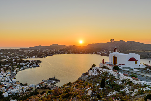 View of Agia Marina village with the Church on top of a hill on Leros island in Greece at sunset.