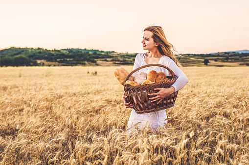 Country Girl In Wheat Field at sunset