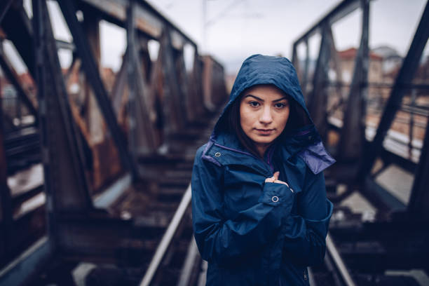 istock Lonely young female on  the railroad tracks 1135175440