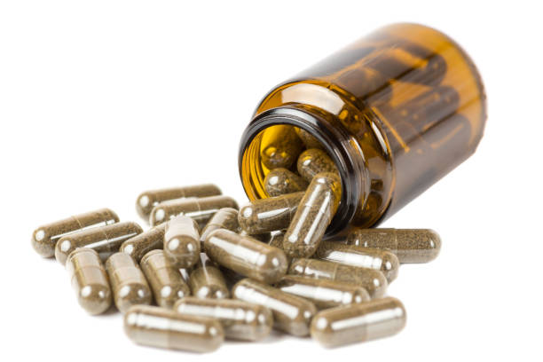 istock Isolate pills or tablets  in the glass brown bottle on a white background. Isolate on a white background 1135177287