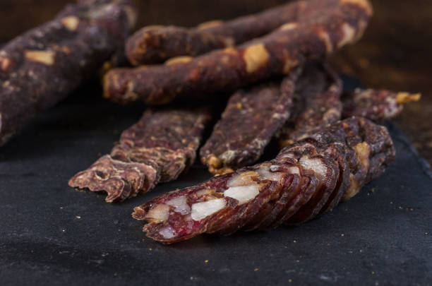 istock Slicing dried jerks. Cutting from jerkov. Meat snack. 1135179147