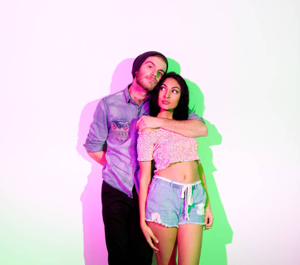 istock Cute young hip couple standing in front of white wall 1135181533