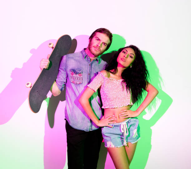 istock Cute young hip couple standing in front of white wall 1135181617