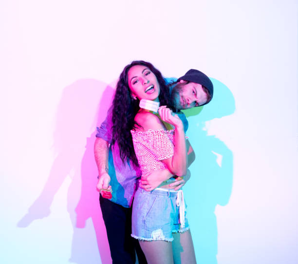 istock Attractive man and woman standing in front of white wall 1135181765