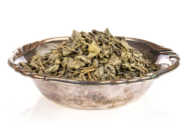 istock Dry green tea isolated on white 1135182587