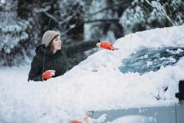 istock Woman Scraping Snow and Ice off Car Windshield 1135182589