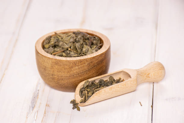 istock Dry green tea on grey wood 1135183170