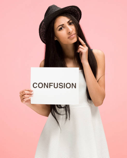 istock Beautiful female on pink background and is feeling confused 1135183781