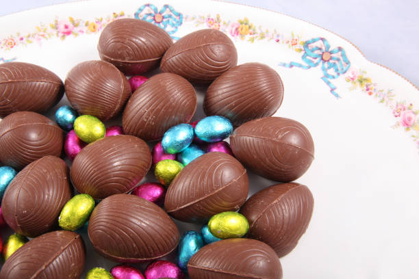 istock Chocolate easter eggs & colourful foil wrapped eggs on a white plate with a traditional flower design. 1135183827