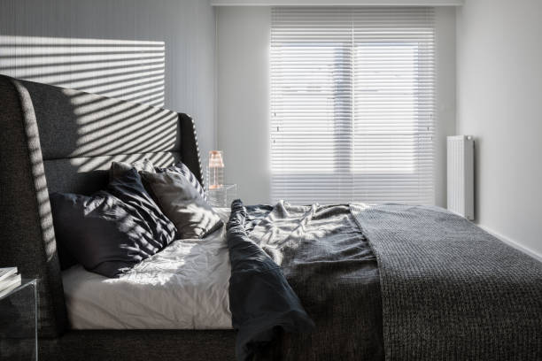 istock Gray bedroom with window blinds 1135184990