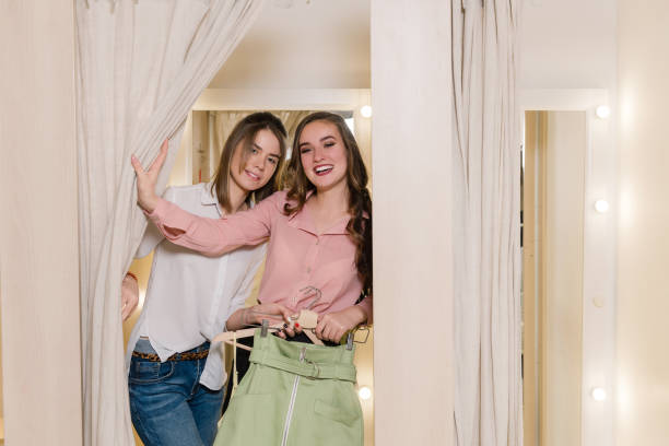 istock Happy girlfriends in fitting room try on clothes. 1135185450