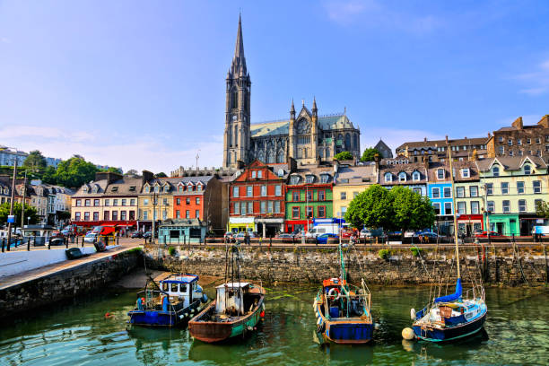 colorful buildings, old boats and cathedral, cobh harbor, county cork, ireland - condado de cork imagens e fotografias de stock